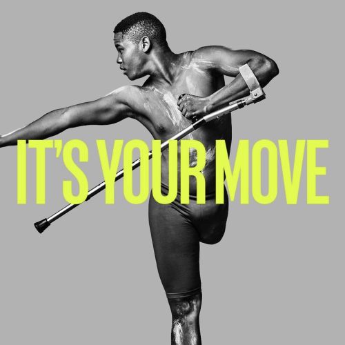 A black and white photo of a dancer with a limb difference. They are using crutches and looking over the the left. Bold yellow text is overlayed and says "it's your move"